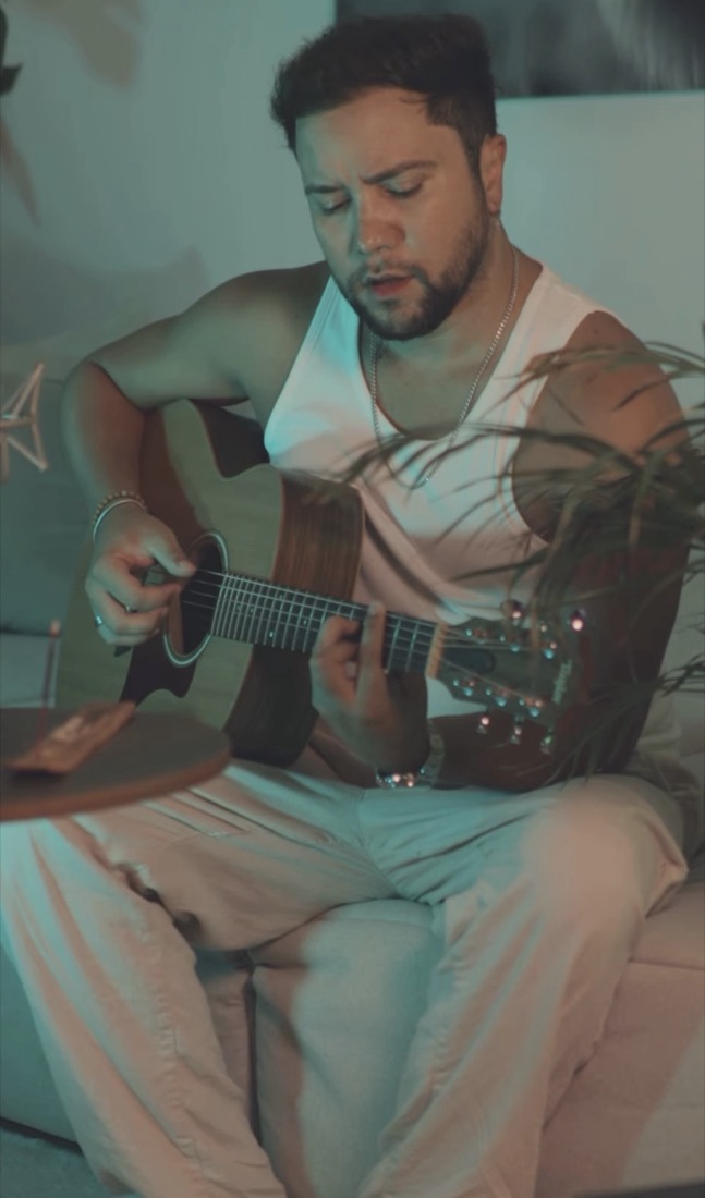 Leon Gabriel playing acoustic guitar
